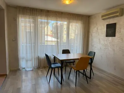 a dining room with a table and chairs and a window at Parchevich 31 Center Apartment - 24h Self Check-in in Sofia