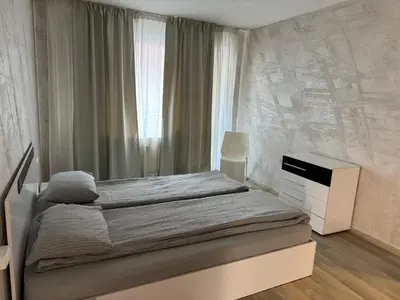 a bedroom with a bed with a dresser and a window at Parchevich 31 Center Apartment - 24h Self Check-in in Sofia