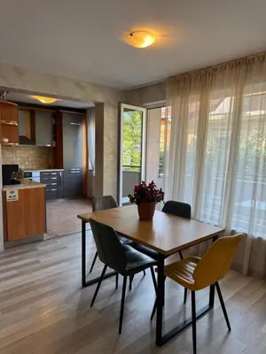 a kitchen and dining room with a wooden table and chairs at Parchevich 31 Center Apartment - 24h Self Check-in in Sofia