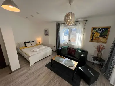 a living room with a bed and a couch at The Yellow House in Sofia in Sofia