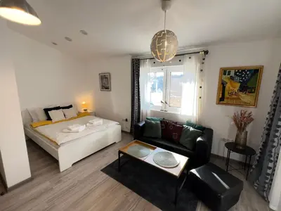 a living room with a bed and a couch at The Yellow House in Sofia in Sofia