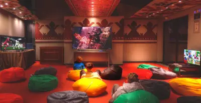 a group of children sitting in a room watching a tv at Euphoria Club Hotel in Borovets