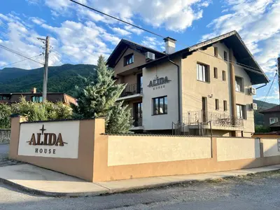 a building with a sign that reads alpha hotel at Къща за гости Алида in Sapareva Banya