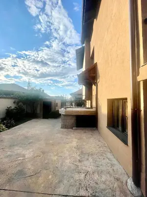 a building with a large patio with a view at Къща за гости Алида in Sapareva Banya