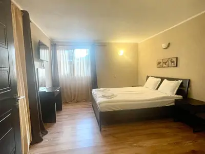 a small bedroom with a bed with white sheets at Къща за гости Алида in Sapareva Banya