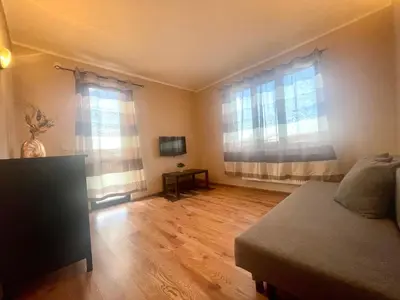 a room with a bed and two windows at Къща за гости Алида in Sapareva Banya