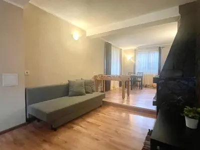 a living room with a couch and a table at Къща за гости Алида in Sapareva Banya
