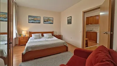 a bedroom with a bed and a couch at PIRIN PLACE Bansko in Bansko