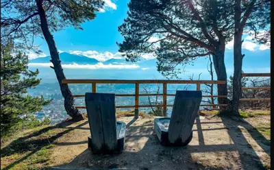 a view from the top of a mountain with two chairs at PIRIN PLACE Bansko in Bansko
