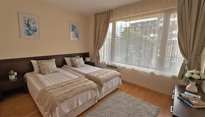 a bedroom with a bed and a large window at PIRIN PLACE Bansko in Bansko