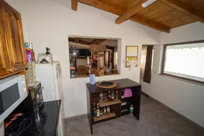 a room with a refrigerator and a table with bottles at Banya Guest Rooms 23 in Banya