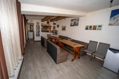 a dining room with a wooden table and chairs at Banya Guest Rooms 23 in Banya