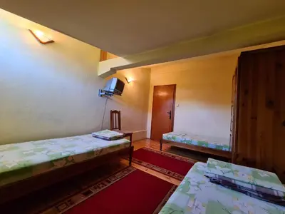 an empty room with two beds and a hallway at Villa Mura in Razlog