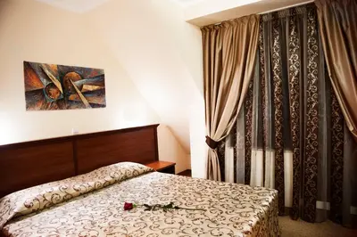 a bedroom with a bed and a painting on the wall at Favorit Hotel in Sofia