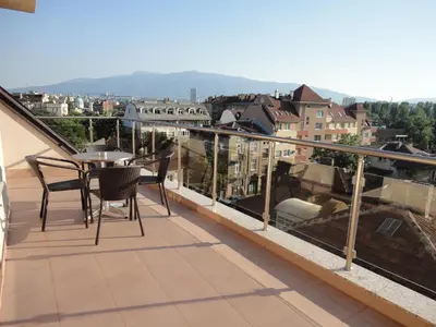 a balcony with a table and chairs and a view at Favorit Hotel in Sofia