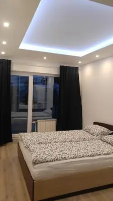 a bedroom with a large bed with a window at Modern apartment Sofia center in Sofia