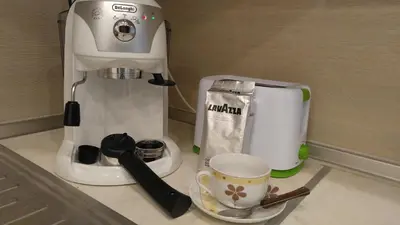 a mixer sitting on a counter next to a cup at Modern apartment Sofia center in Sofia