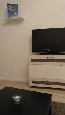 a living room with a flat screen tv on a dresser at Modern apartment Sofia center in Sofia