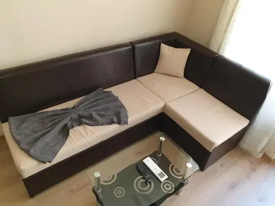 a black couch with a blanket on top of it at Cosy Apartment - City Centre in Blagoevgrad