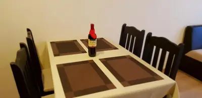 a bottle of wine sitting on top of a table at Cosy Apartment - City Centre in Blagoevgrad