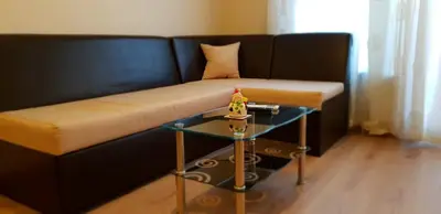 a couch with a table next to a side table at Cosy Apartment - City Centre in Blagoevgrad