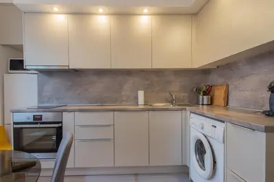 a kitchen with white cabinets and a dishwasher at CHIC and Spacious Apartment in Central Sofia - Patriarh Evtimiy by Flat Mаnager in Sofia