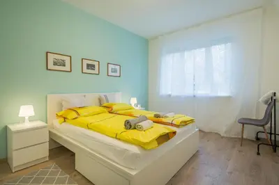 a bedroom with a large bed with yellow sheets at CHIC and Spacious Apartment in Central Sofia - Patriarh Evtimiy by Flat Mаnager in Sofia