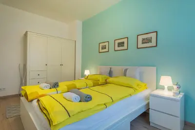 a bedroom with a large yellow bed with yellow sheets at CHIC and Spacious Apartment in Central Sofia - Patriarh Evtimiy by Flat Mаnager in Sofia