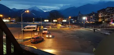 a parking lot at night with cars parked in it at EFO Apartment in Bansko