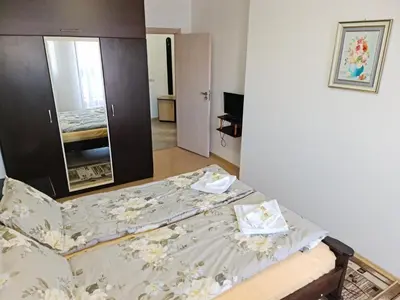 a bedroom with a bed with a dresser at EFO Apartment in Bansko