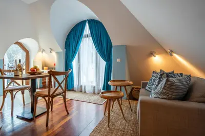 a living room with a table and a couch at RENOVATED Boutique Apartments Petrus in Sofia