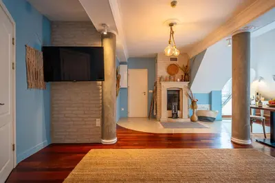 a living room with a brick wall and a fireplace at RENOVATED Boutique Apartments Petrus in Sofia