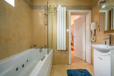 a bathroom with a tub and a sink and a shower at RENOVATED Boutique Apartments Petrus in Sofia