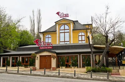 a yellow building with a sign on top of it at RENOVATED Boutique Apartments Petrus in Sofia