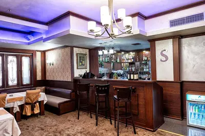 a restaurant with a bar with stools in it at Platinum Image Hotel in Elin Pelin