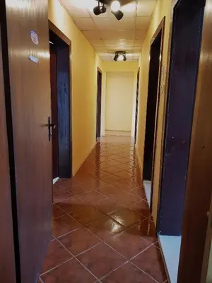 a hallway with a tiled floor in a building at Oleander Rooms & Apartment in Sofia