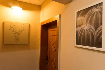a hallway with a picture of a deer on the wall at Oleander Rooms & Apartment in Sofia