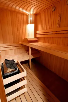 an empty sauna with a table and a light in it at Hotel Rai in Sofia
