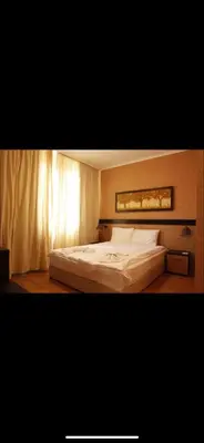 a bedroom with a large white bed in it at Pravets Resort Apartments in Pravets