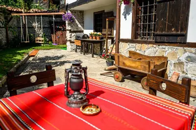 a table with a red table cloth on top of it at Banskovilla Zlateva House in Bansko