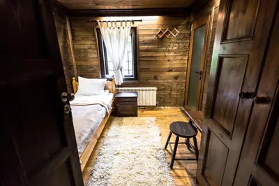 a small room with a bed and a window at Banskovilla Zlateva House in Bansko
