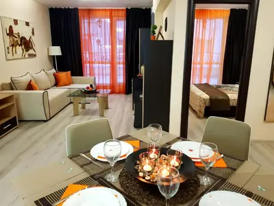 a living room with a dining table and a living room at Best Guest Apartments in Plovdiv