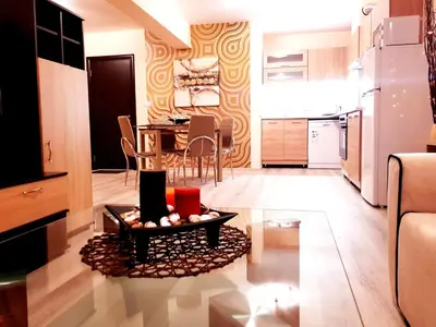 a kitchen and living room with a table and chairs at Best Guest Apartments in Plovdiv
