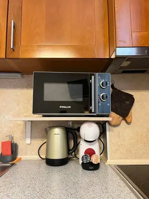 a microwave oven sitting on a shelf in a kitchen at Budapest Central Cozy Studio w Working Space and WiFi in Sofia