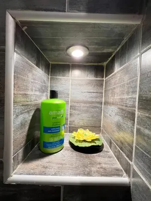 a green bottle of sunscreen sitting on a shelf in a shower at Budapest Central Cozy Studio w Working Space and WiFi in Sofia