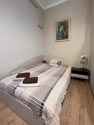a bedroom with a bed with two towels on it at Budapest Central Cozy Studio w Working Space and WiFi in Sofia