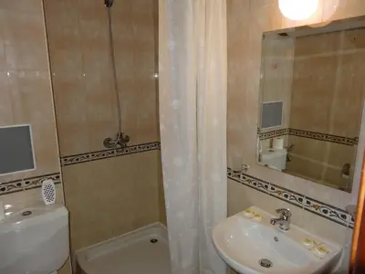 a bathroom with a sink and a toilet and a shower at Apartment Biliana in Pamporovo