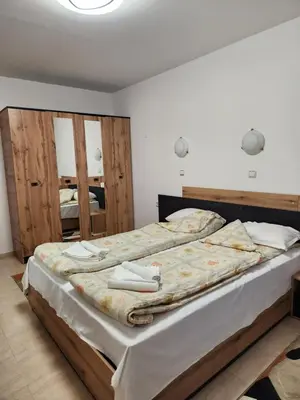 a bedroom with two beds and two mirrors at Apartment Biliana in Pamporovo