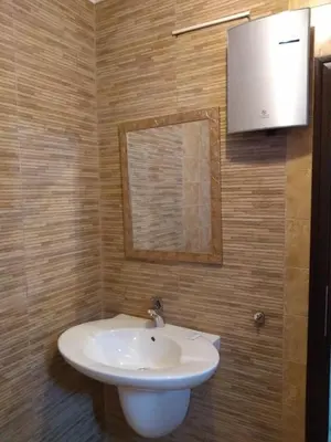 a bathroom with a white sink and a mirror at Guesthouse White Margarit in Melnik