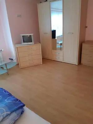 a bedroom with a desk with a computer on a dresser at Guest House Iveta in Sofia